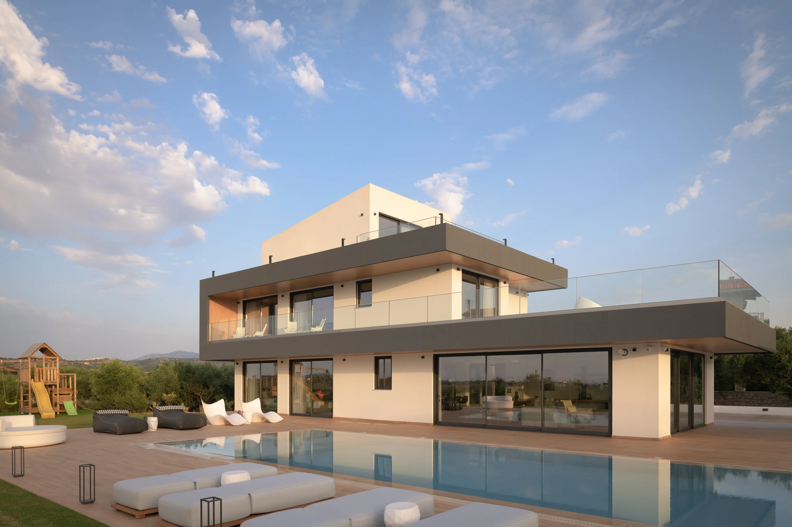 Villa and furnished pool terrace in the evening light at Aesthea Exclusive Villa